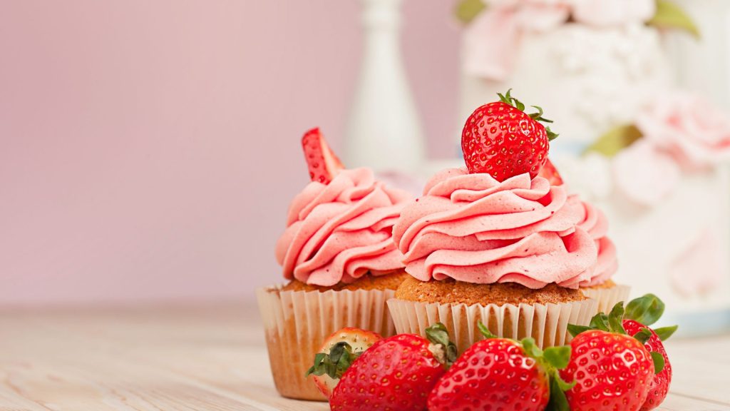 Cupcakes with strawberry on top and pink blurred background strawberry desktop wallpaper