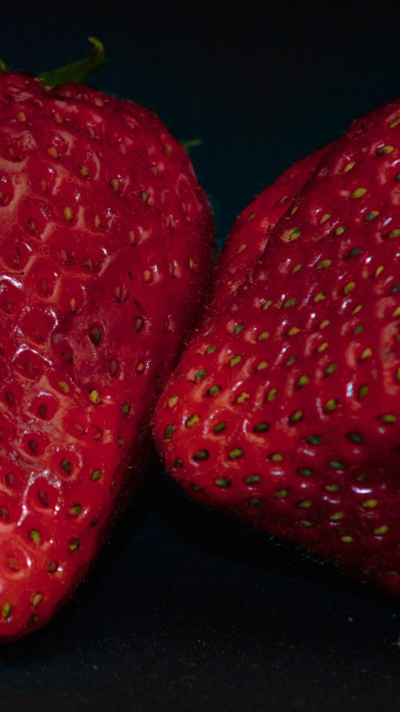 Plum red strawberries with black background strawberry phone wallpaper