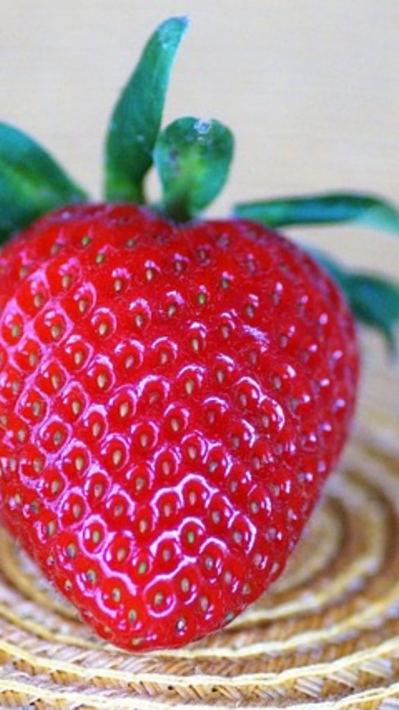 Plum red strawberry on jute plate strawberry phone wallpaper