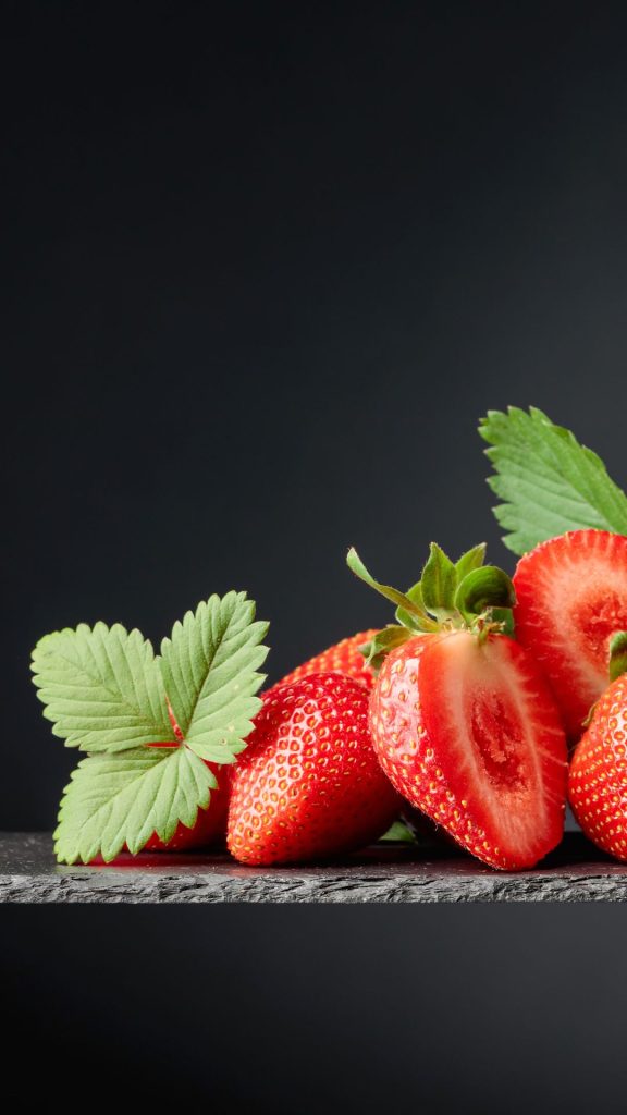 Red strawberries on granite with black background strawberry phone wallpaper