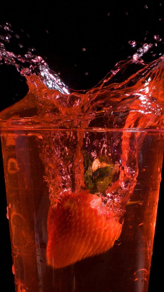 Strawberry splashing in juice glass strawberry phone wallpaper
