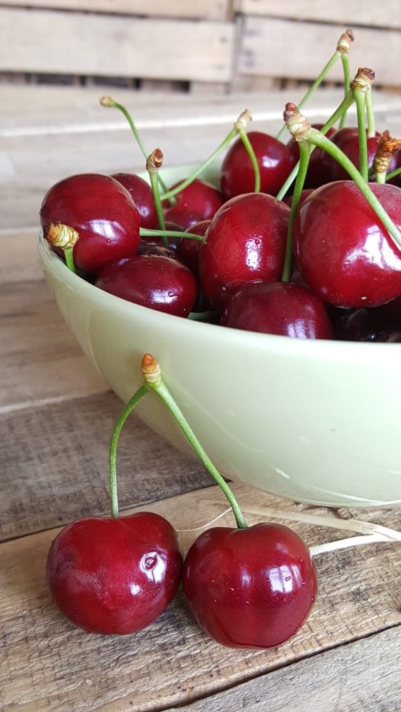 A bowl filled with cherries with vintage background aesthetic cherry wallpapers