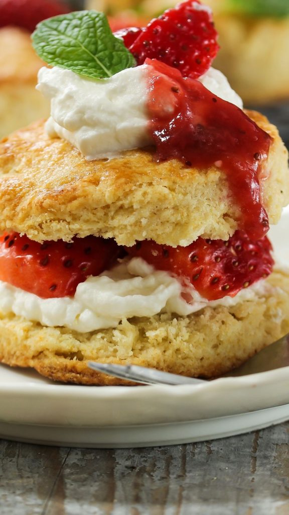 Cake with strawberries and cream and mint leaves in white plate strawberry shortcake wallpaper