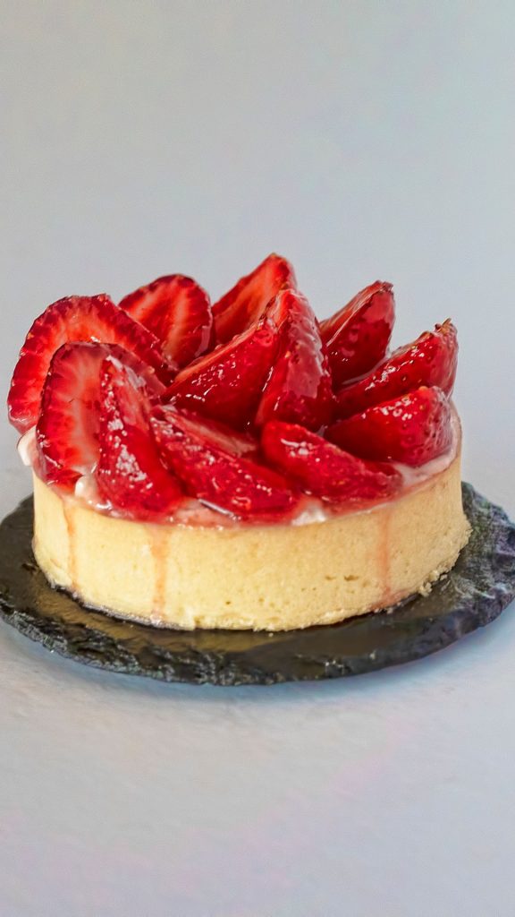 Cheesecake with strawberries and jam on aesthetic plate with grey background strawberry shortcake wallpaper