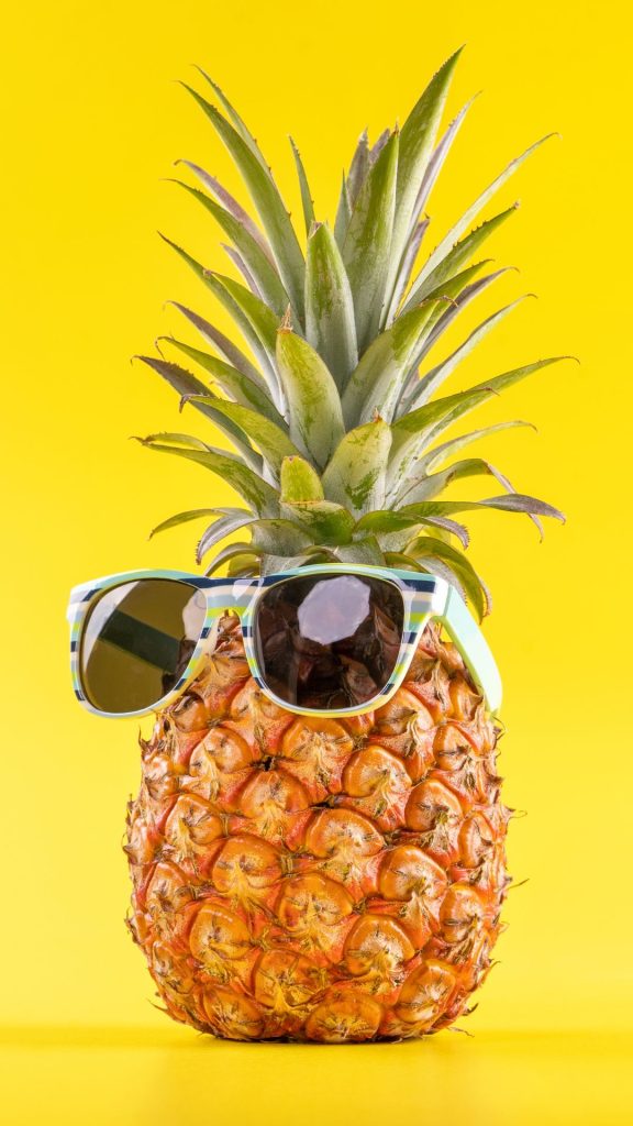 Cool pineapple with cool glasses on plain yellow background Pineapple wallpaper