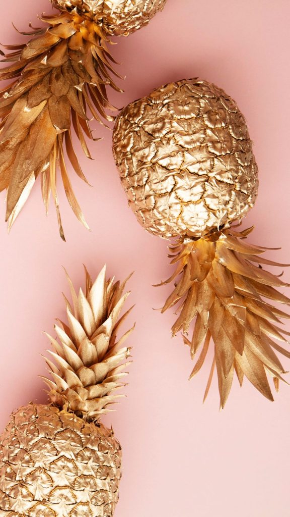 Cool pineapples in golden colour on plain baby pink background Pineapple wallpaper