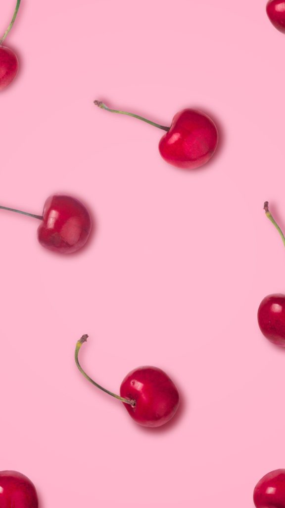 Cute little red cherries with baby pink background aesthetic cherry wallpapers