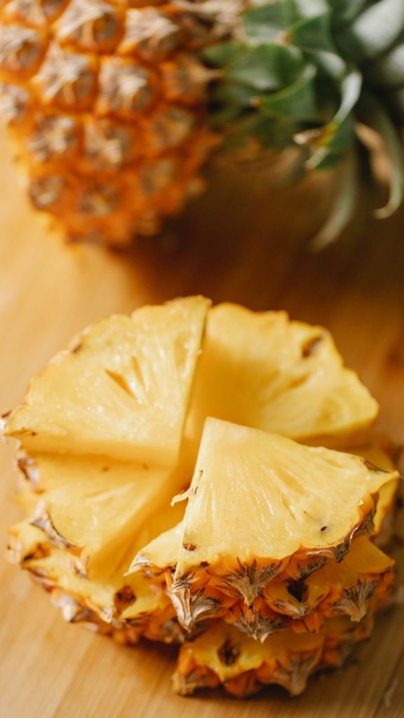 Fresh pineapple pieces with blurred pineapple background Pineapple wallpaper