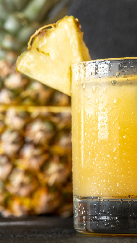 Glass of fresh pineapple juice with pineapple background Pineapple wallpaper