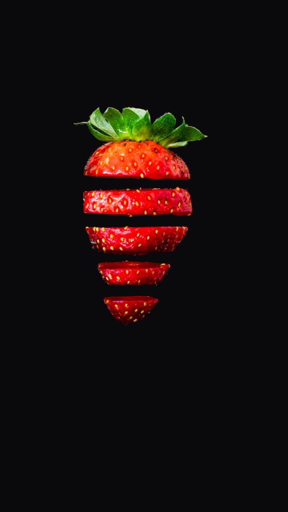 Juicy strawberry with black background in the back Strawberry Background Wallpaper