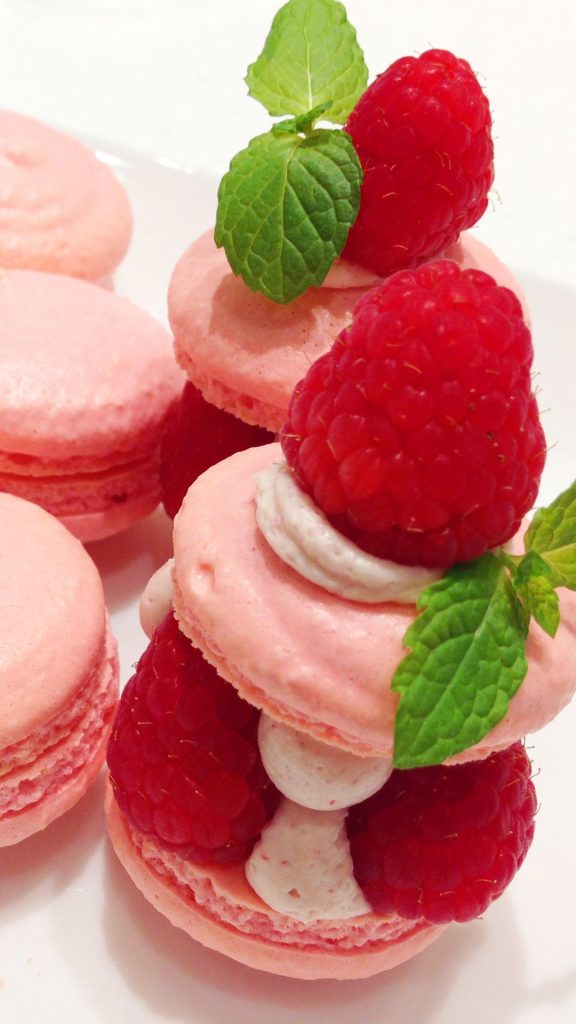 Macaroons with berries and mint leaves pastel pink strawberry wallpaper