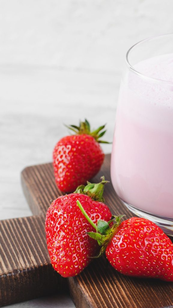 Pink strawberry milkshake glass with strawberries Strawberry Background Wallpaper