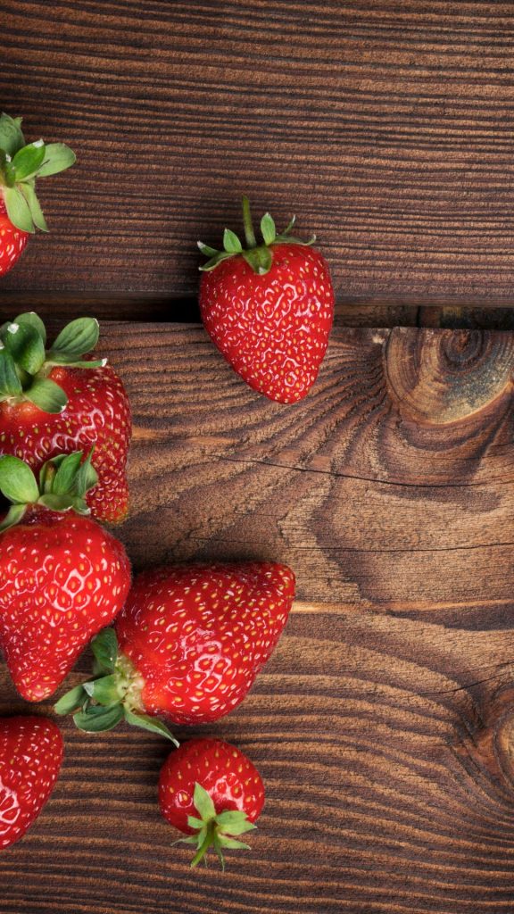 Red juicy strawberries on wooden table Strawberry Background Wallpaper