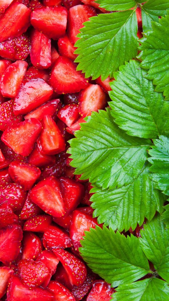 Red juicy strawberries with big green leaves Strawberry Background Wallpaper