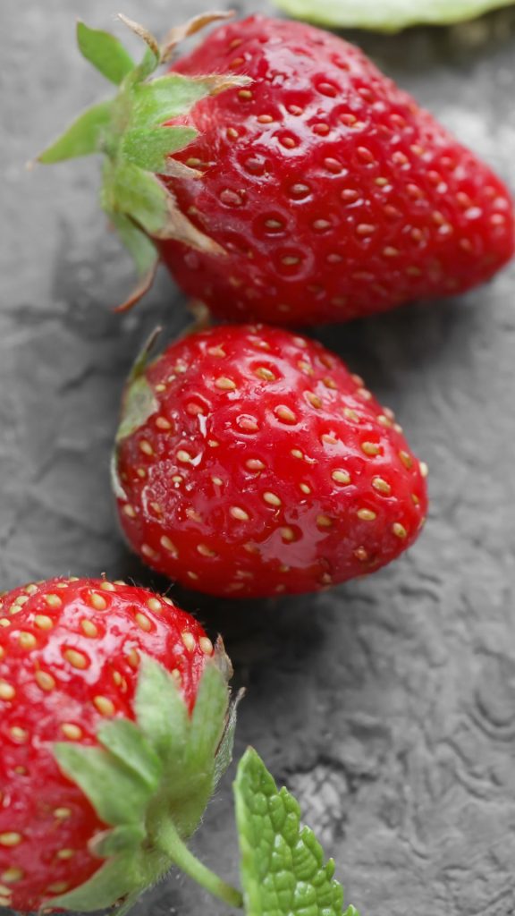 Red strawberries on grey tiles Strawberry Background Wallpaper