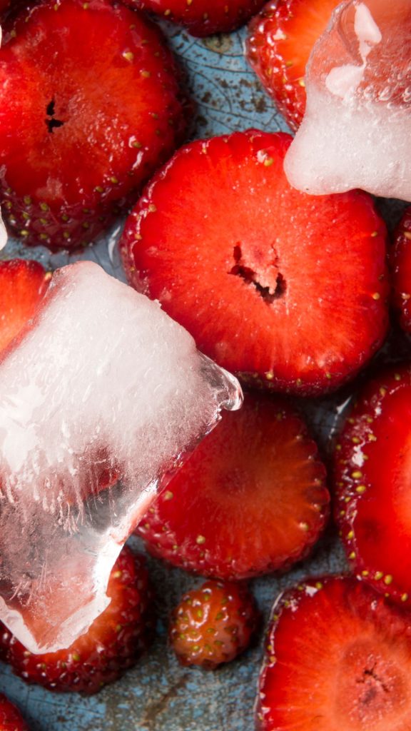 Red strawberries with ice cubes Strawberry Background Wallpaper