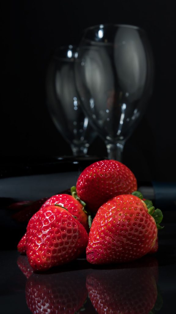 Red strawberries with vine glass and black background strawberry wallpaper for I phone