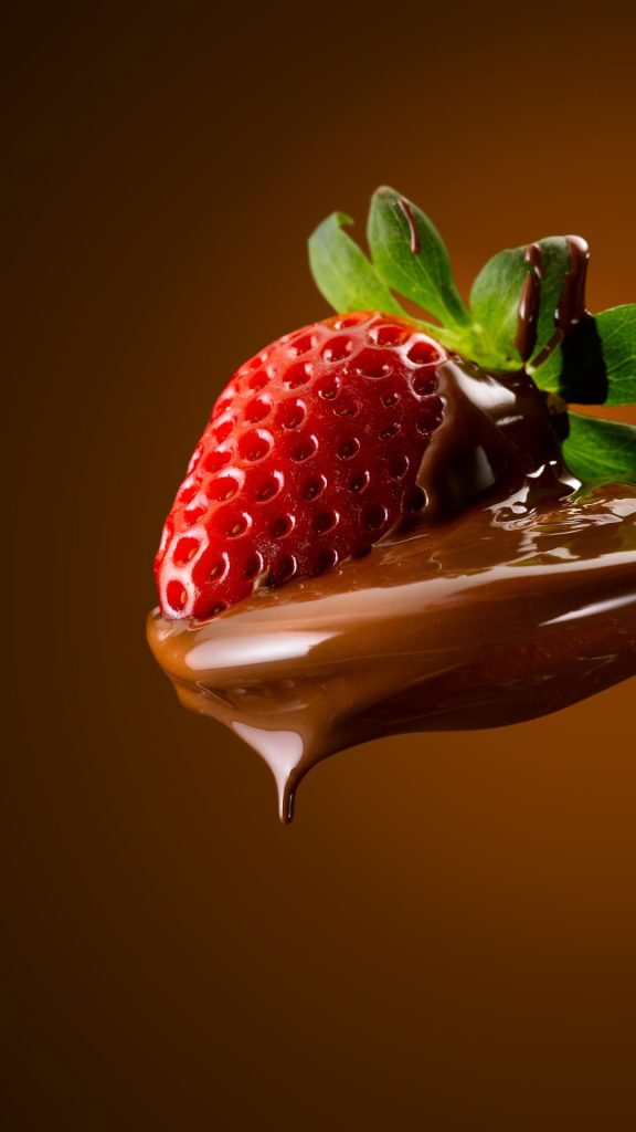Red strawberry with chocolate in spoon with brown background strawberry wallpaper for I phone