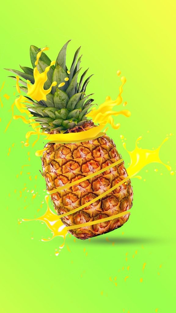 Splashing juice from pineapple with plain yellow background Pineapple wallpaper