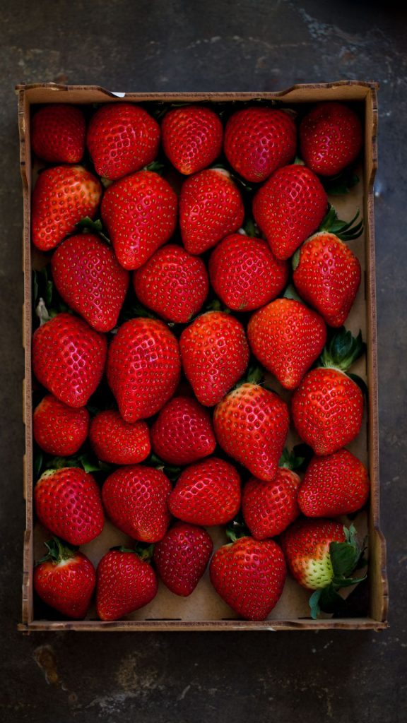 Strawberries in vintage wooden box on grey marble Strawberry Background Wallpaper f