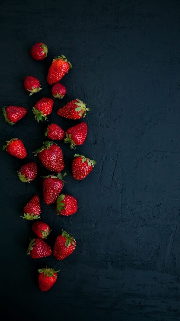 Strawberries on black vintage background Strawberry Background Wallpaper