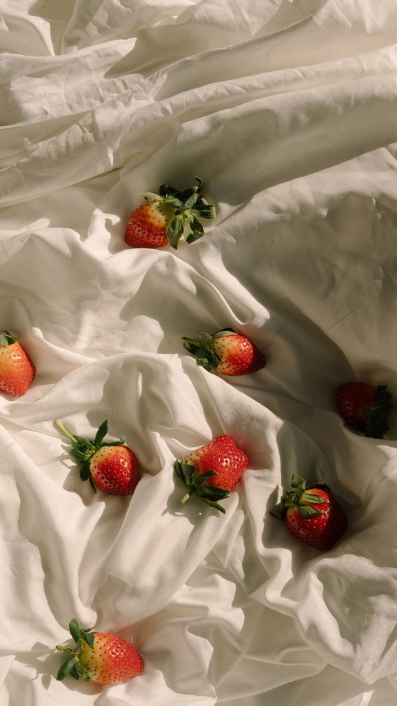 Strawberries with silk background in white Strawberry Background Wallpaper