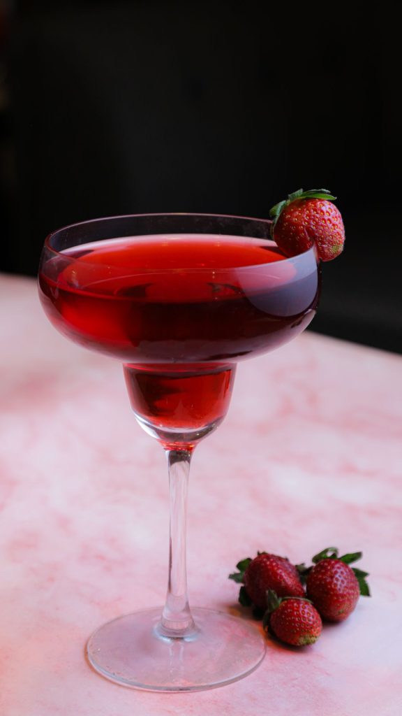 Strawberry cocktail glass with strawberries and vintage background Strawberry Background Wallpaper