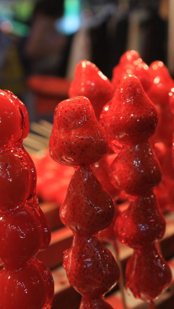 Sugar coated strawberry candy sticks with blurred background strawberry wallpaper for I phone