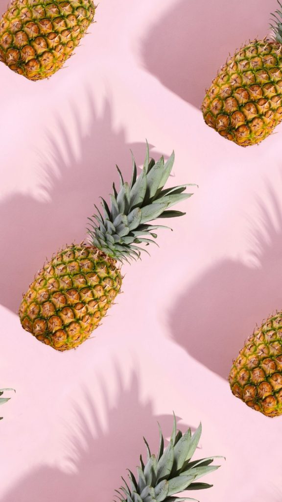 Sweet and delicate pineapples with shadows on baby pink background Pineapple wallpaper