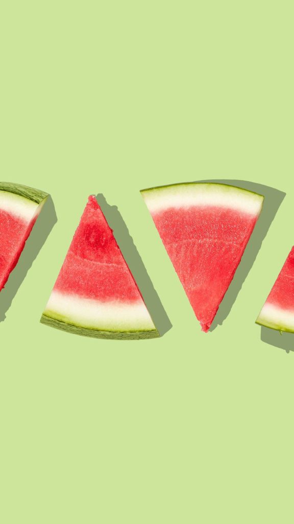 Aesthetic watermelon pieces with light parrot colour background watermelon wallpaper