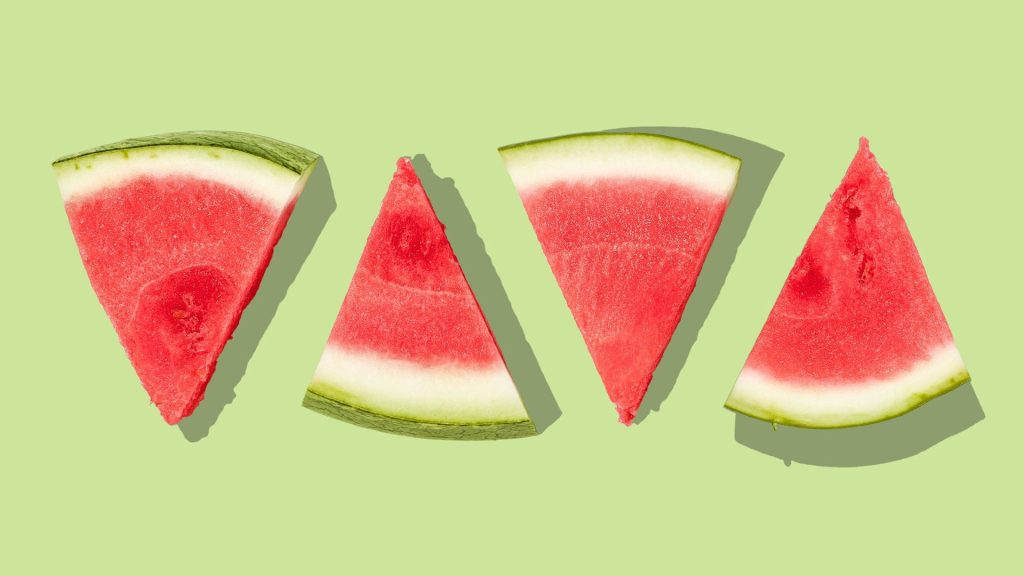 Red watermelon pieces with green background watermelon wallpaper