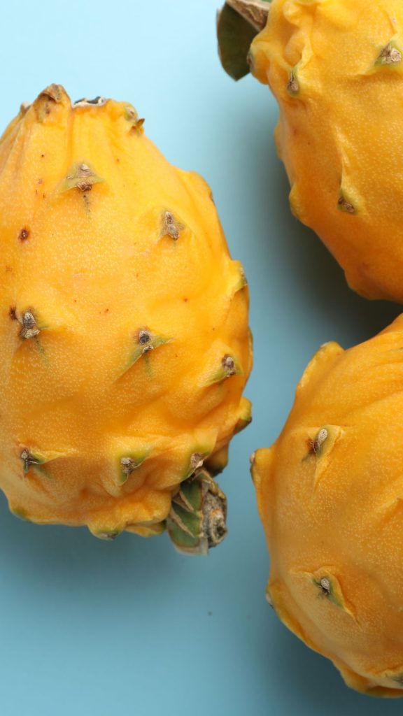 Sky blue background yellow dragon fruit wallpaper