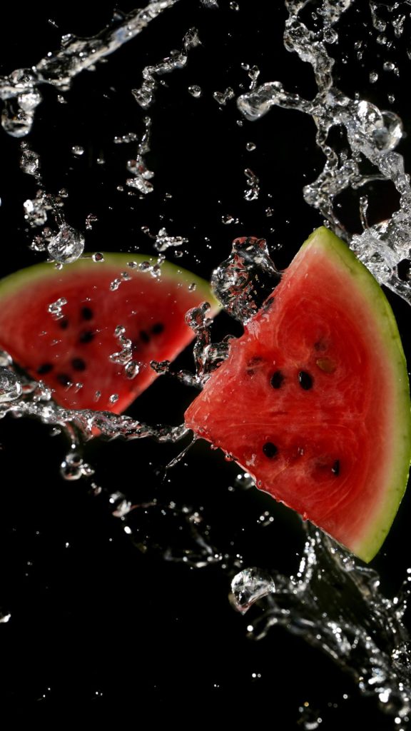 Watermelon pieces with black background and water splashing watermelon wallpaper