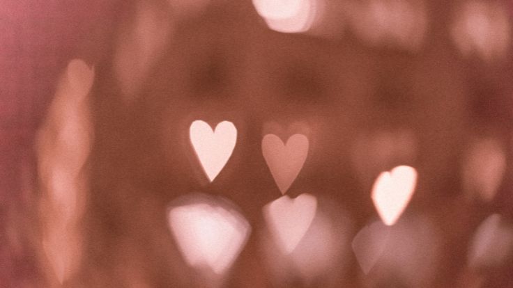 Soft bokeh background with blurred glowing white hearts pink wallpaper