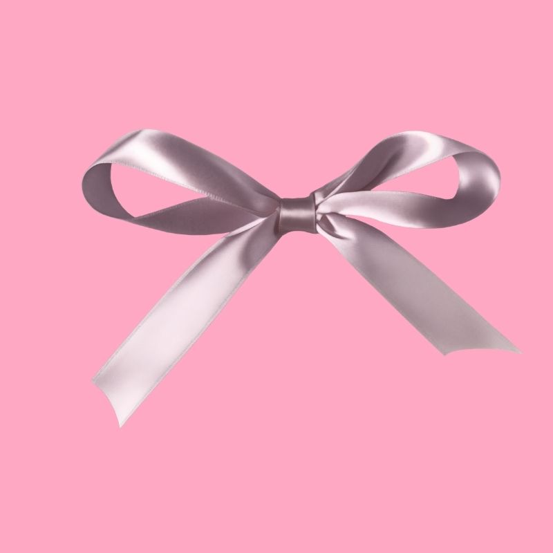 A silver ribbon elegantly draped on a soft pink background