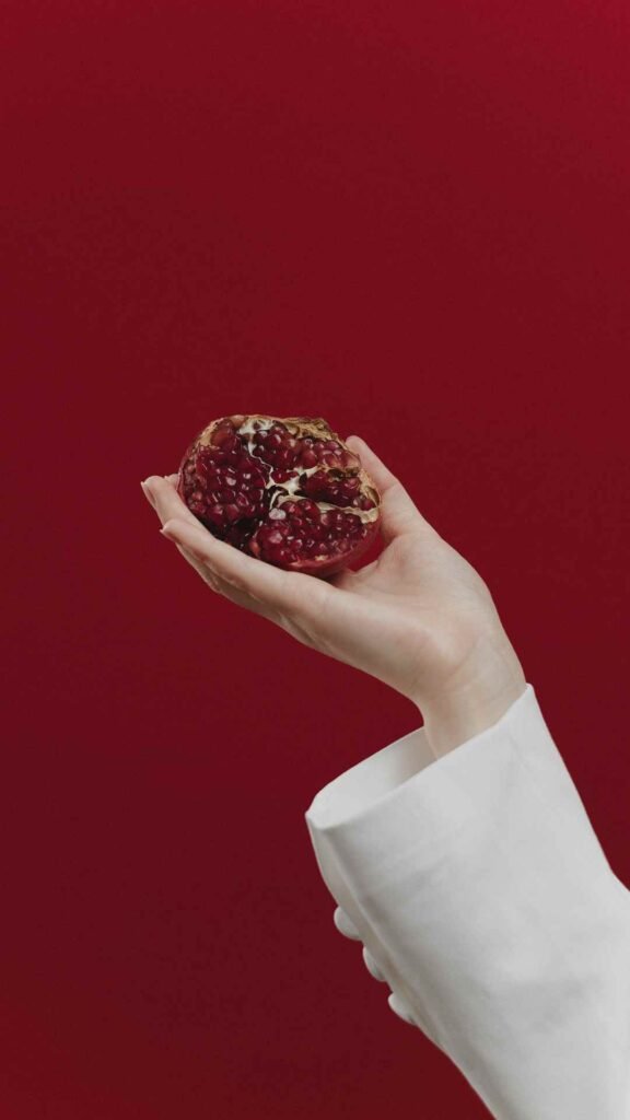 Pomegranate fruit wallpaper with green leaves