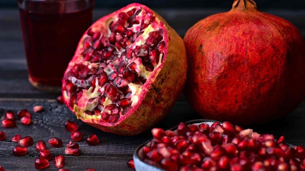 Pomegranate wallpaper with green leaves