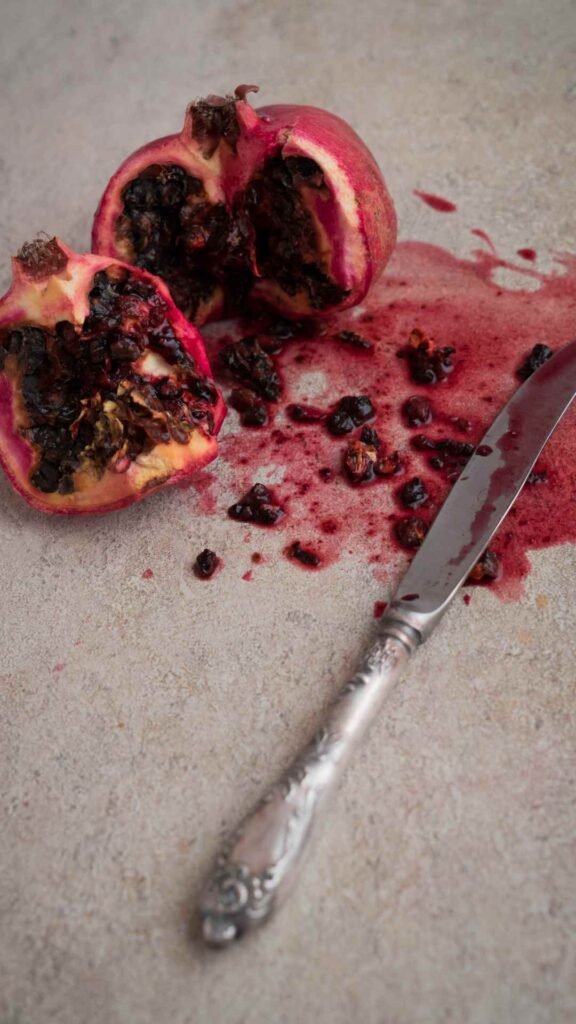 Red botanical wallpaper featuring pomegranate